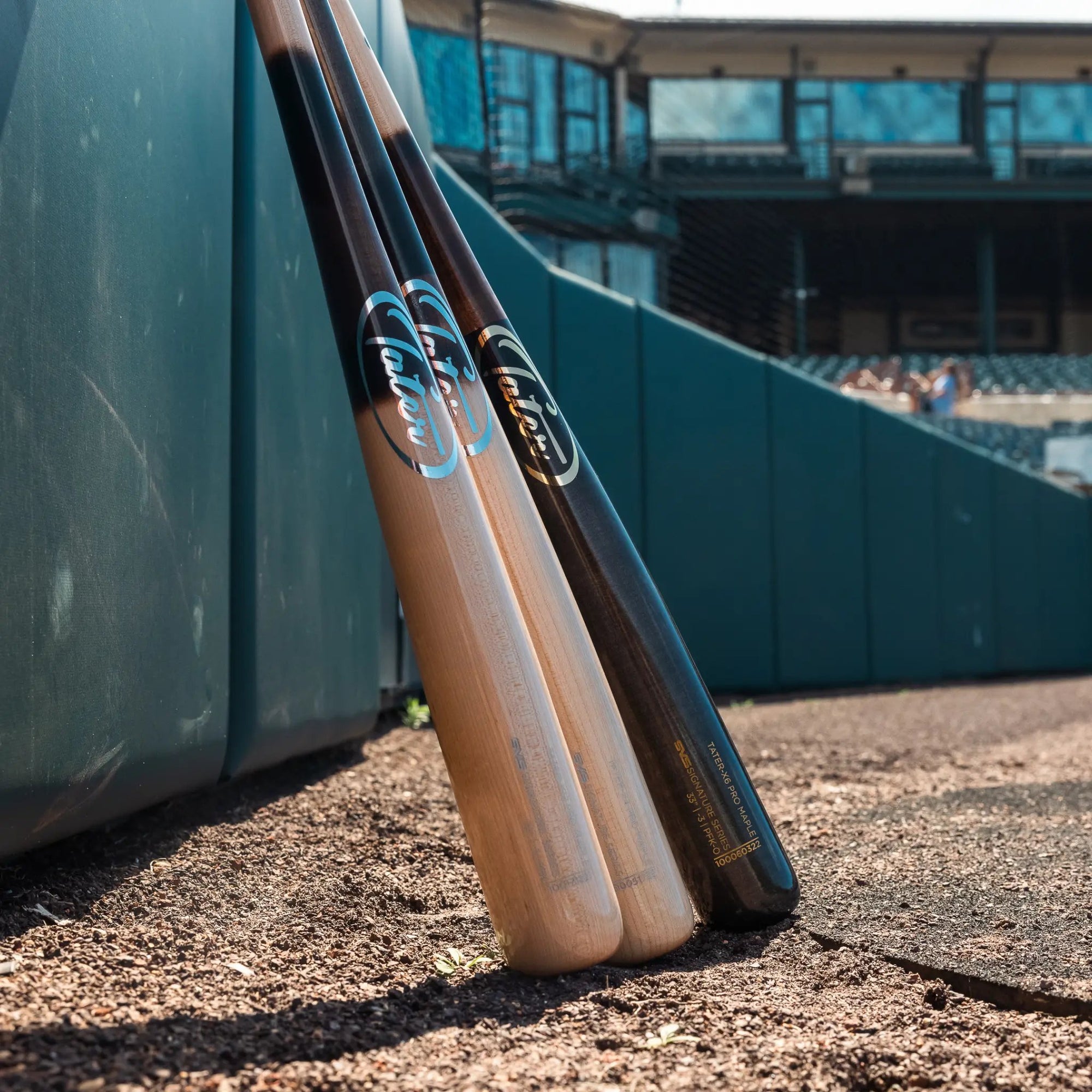 Tater-X4 Pro Maple Wood Bat placed over home plate of Prince George's Stadium