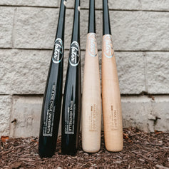 Tater custom maple wood bats including the slight end-load U238 model lined up against a cinder block wall