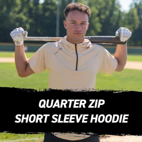 TC Simmons wearing a premium cream colored short sleeve quarter zip hoodie made by Tater Baseball.