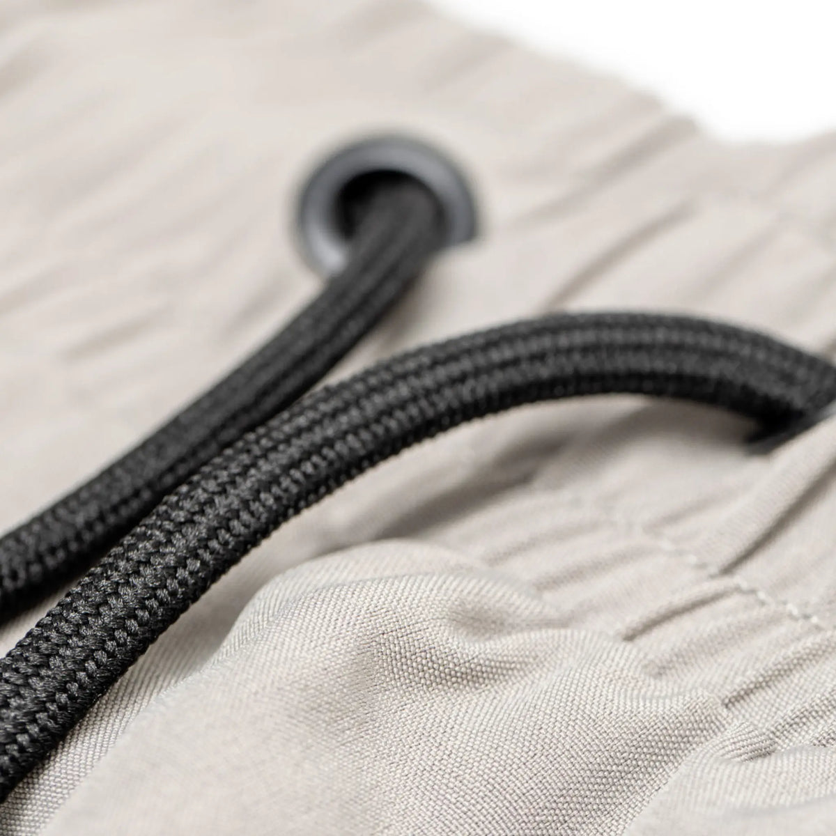 The image displays a close-up view of the drawstring detail on a pair of Tater Baseball grey shorts, highlighting the textured fabric and the quality of the eyelet and cord.