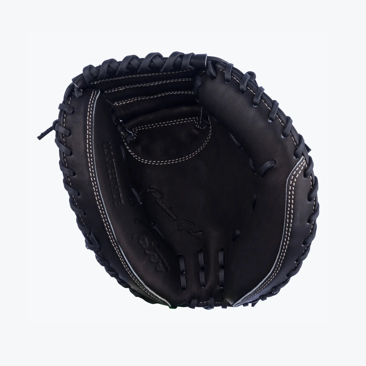 This image showcases the inside view of Tater Baseball&#39;s black catcher&#39;s mitt, a 28-inch mini trainer. The mitt&#39;s compact design is emphasized by the detailed white stitching and embossed logo, engineered for catchers to practice and master their craft with a focus on control and quick transfer.