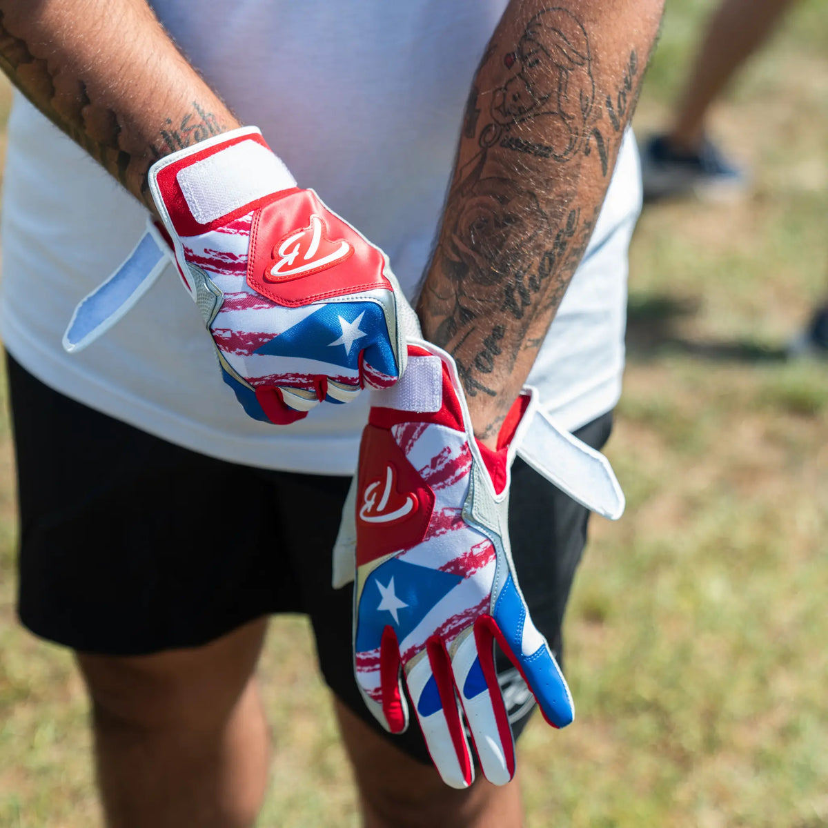 Baseball player gearing up with premium Tater batting gloves featuring a bold Puerto Rican flag design, a symbol of pride and performance on the diamond.