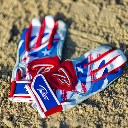 Tater batting gloves with a vibrant Puerto Rican flag design resting on the sandy texture of a baseball field, symbolizing the fusion of cultural pride and sport.