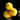 Hand holding three yellow Tater foam softballs, two showing the TB logo