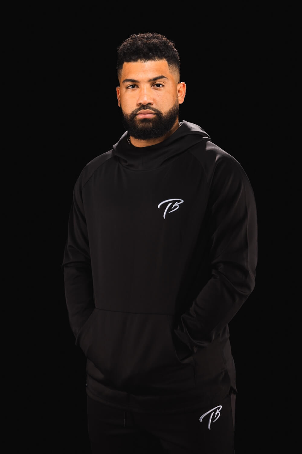 Long sleeve black athletic fitness hoodie with stylized TB on the chest